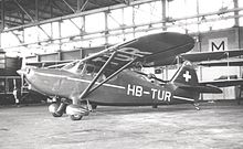 Airplane Picture - Swiss Stinson 108-2 at Manchester Airport, England in 1950. This earlier model has the shorter vertical fin with curved trailing edge.