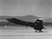 Airplane Picture - X-15 touching down on its skids. Compare jettisoned lower ventral fin with color picture, top.