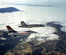 Airplane Picture - An air-to-air right side view of a YF-16 aircraft and a YF-17 aircraft, side-by-side, armed with AIM-9 Sidewinder missiles