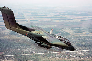 Warbird Picture - A USAF OV-10A firing a white phosphorus smoke rocket to mark a ground target