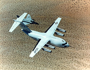 Warbird Picture - First YC-15 prototype conducting flight testing, accompanied by an F-4 Phantom II.