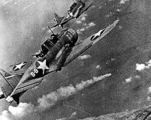 U.S. Douglas SBD-3 Dauntless dive bombers about to attack the burning cruiser Mikuma for the third time