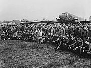 Airplane Pictures - Brigadier General Anthony C. McAuliffe, artillery commander of the 101st Airborne Division, talks to paratroopers on D-Day minus 1, behind can be seen a CG-4 Waco glider and C-47s