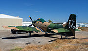 Douglas Skyraider parked at airport ramp.