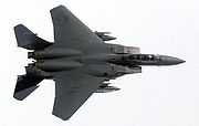 Airplane picture - A wing over maneuver displays the clean lines and high-wing design of an F-15E from Elmendorf AFB, AK.