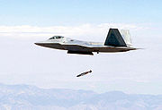 Airplane Pictures - An F-22 releases a JDAM from its center internal bay while flying at supersonic speed