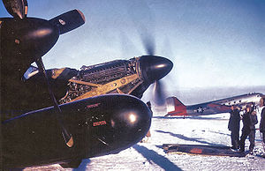 Airplane Pictures - Mechanics work on the port engine of a Twin Mustang in the bitter Alaskan winter cold, 1950