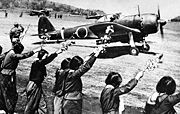 Airplane Pictures - A Nakajima Ki-43 III-Ko Oscar sets off from a Japanese airfield on a kamikaze mission in the Okinawa area on 12 April 1945 as high school girls wave farewell