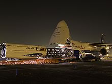 Airplane Picture - Polet Airlines An-124 being loaded with 1/3 model of an Airbus A380 centre fuselage section in Emirates Airline livery.