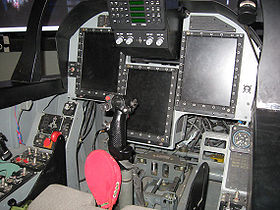 Airplane picture - The JF-17 cockpit on display. The centre stick, up-front control panel, three multi-function displays and part of the throttle stick are visible, as are various switches and indicator lights