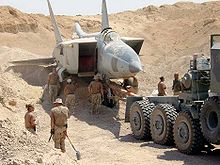 Airplane Picture - Iraqi MiG-25 found buried under the sand at Al Taqaddum Airbase, Iraq. 29 February 2004