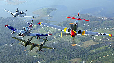 An A-10 Thunderbolt II, F-86 Sabre, P-38 Lightning and P-51 Mustang fly in formation during an air show at Langley Air Force Base, Virginia