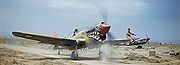 Airplane Pictures - A Kittyhawk Mk III of No. 112 Squadron RAF, taxiing at Medenine, Tunisia, in 1943. A ground crewman on the wing is directing the pilot, whose view ahead is hindered by the aircraft's nose