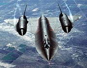 Airplane Pictures - An air-to-air overhead front view of an SR-71A strategic reconnaissance aircraft. Note the water vapor, condensed by the low-pressure vortices generated by the chines outboard of each engine inlet