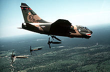 Airplane Picture - A-7D-7-CV air dropping Mark 82 hi-drag bombs over the Tyndall Air Force Base range.