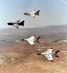 Airplane Picture - Prototype YA-7Ds 67-14582 and 67-14584, along with 69-6191 and 69-6217 making last flyover retirement formation over Edwards AFB, California, heading to AMARC, August 1992