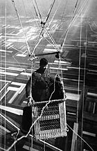 Close-up view of an American major in the basket of an observation balloon flying over territory near front lines.