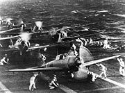 Airplane Pictures - A6M2 Zero Model 21 (front) on Shokaku. (Shokaku distinguisable from the white band on the fuselage just ahead of the tail) to attack Pearl Harbor during the morning of 7 December 1941. This is probably the launch of the second attack wave. The original photograph was captured on Attu in 1943